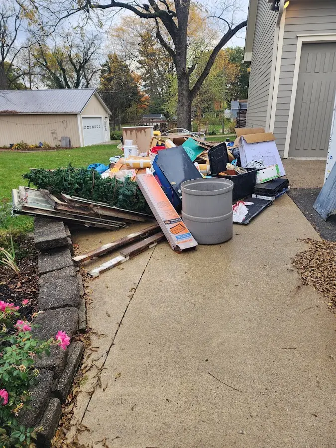 Dumpster being loaded with debris for 3 Yard Dumpster Rental in Sweeny
